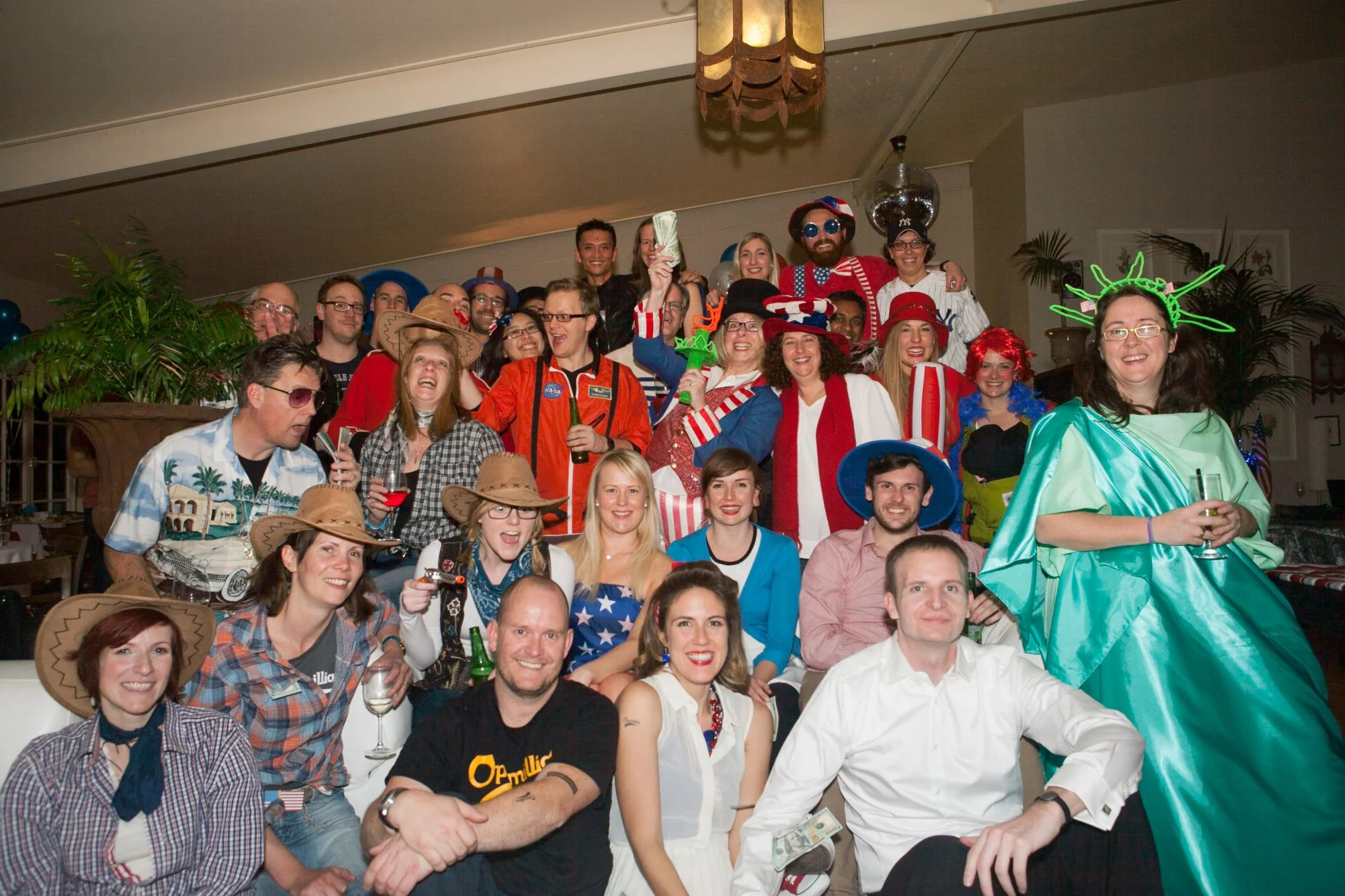 The Optimal team posing together in costume at a party