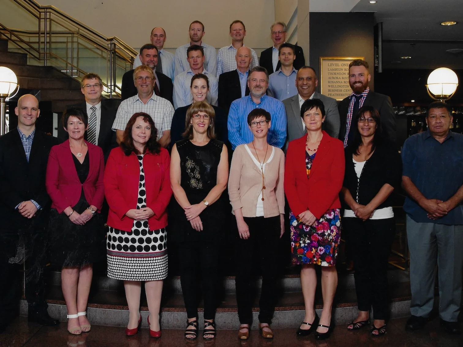 A large group photo of the Institute of Directors course cohort on a staircase