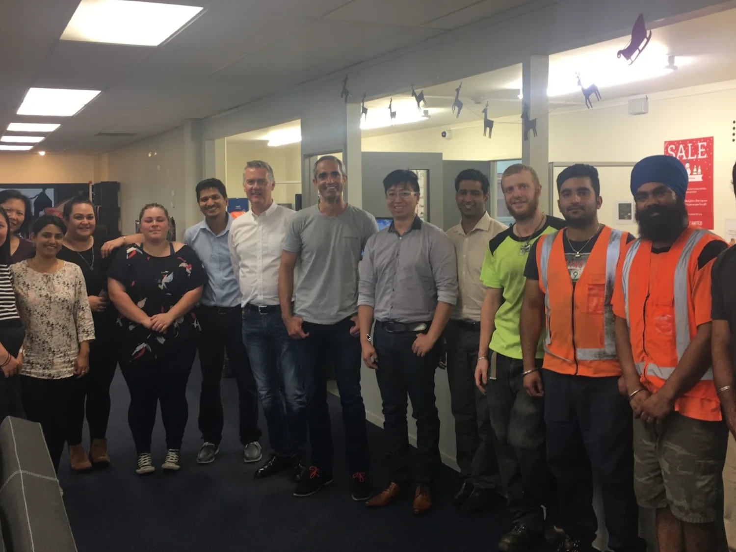 Trent with a group of staff at a customer's workplace
